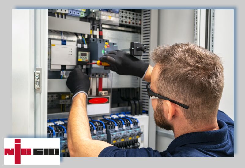 Electrician working on a distribution board, NICEIC approved